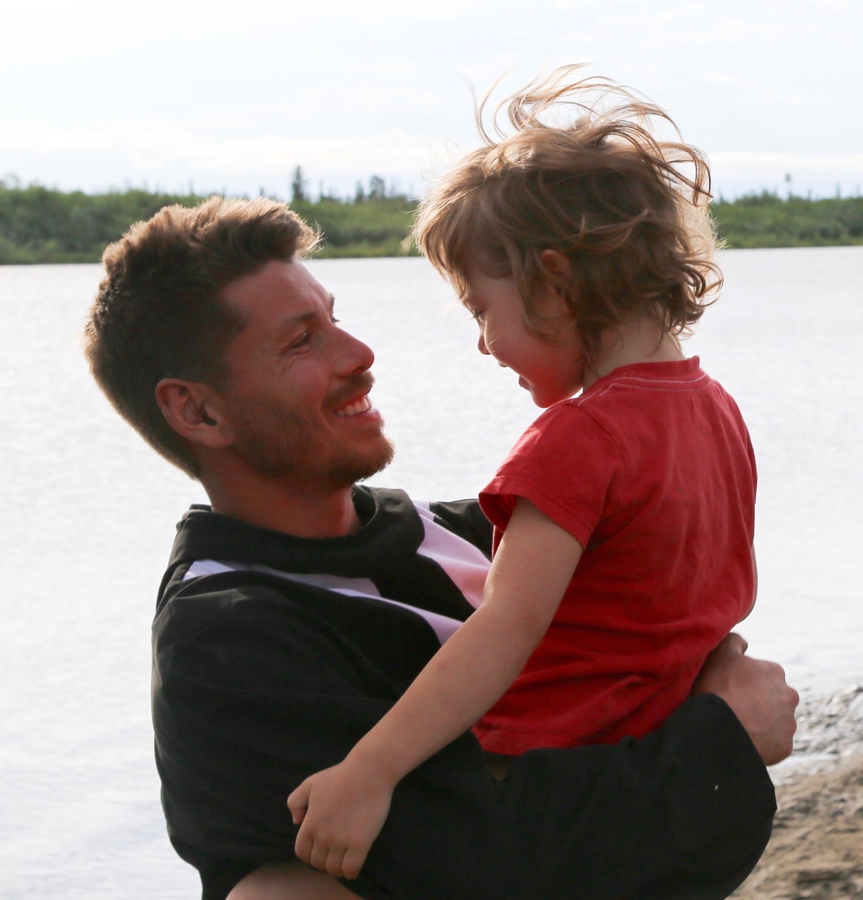 Father Kylik holding autistic daughter in Inuvik 