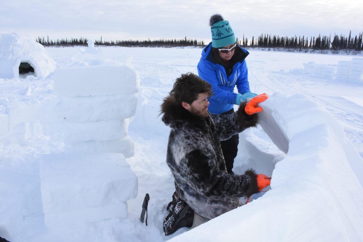 After reindeer herding, visitors learn how to build an igloo.